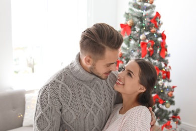 Happy young couple celebrating Christmas at home