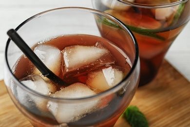 Photo of Glasses of refreshing iced tea on table, closeup