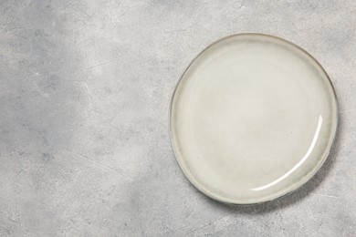 Photo of One ceramic plate on light table, top view. Space for text