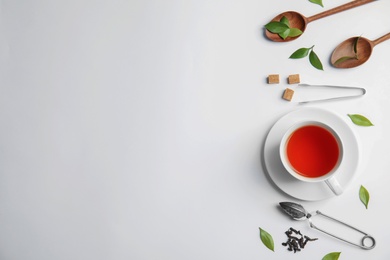 Flat lay composition with delicious tea on light background