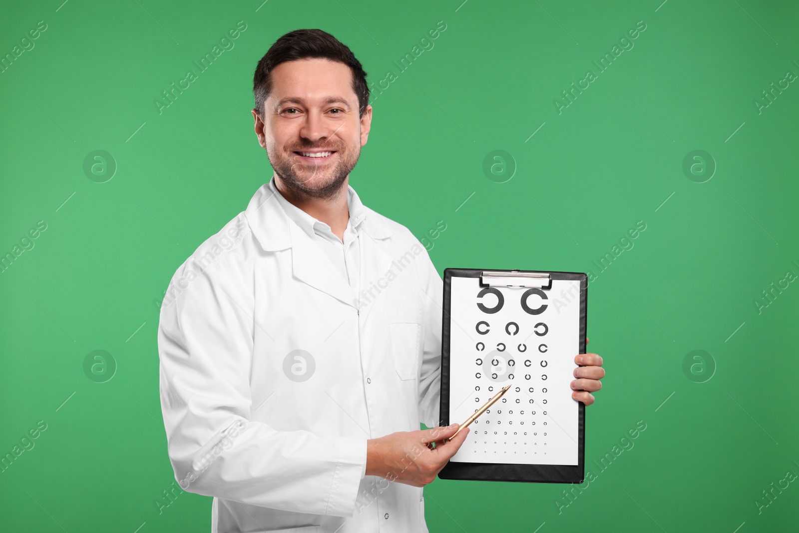 Photo of Ophthalmologist pointing at vision test chart on green background