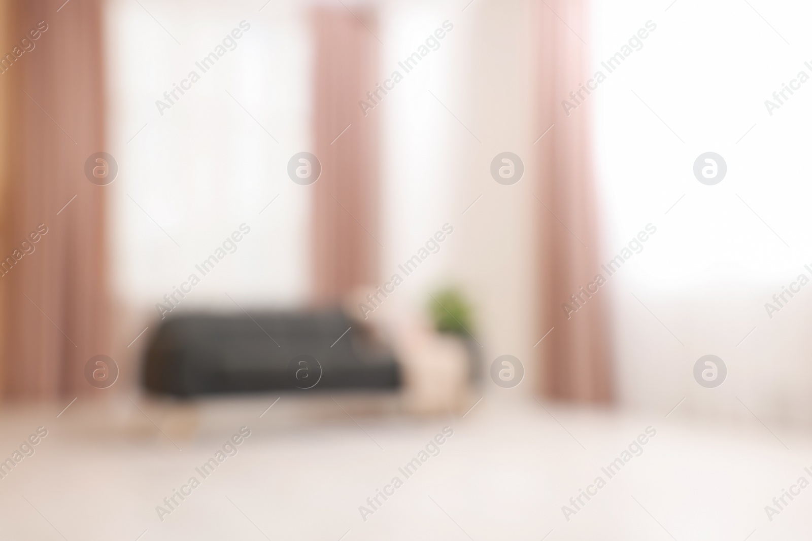 Photo of Blurred view of living room with sofa and curtains