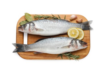 Photo of Board with fresh sea bass fish and ingredients on white background, top view