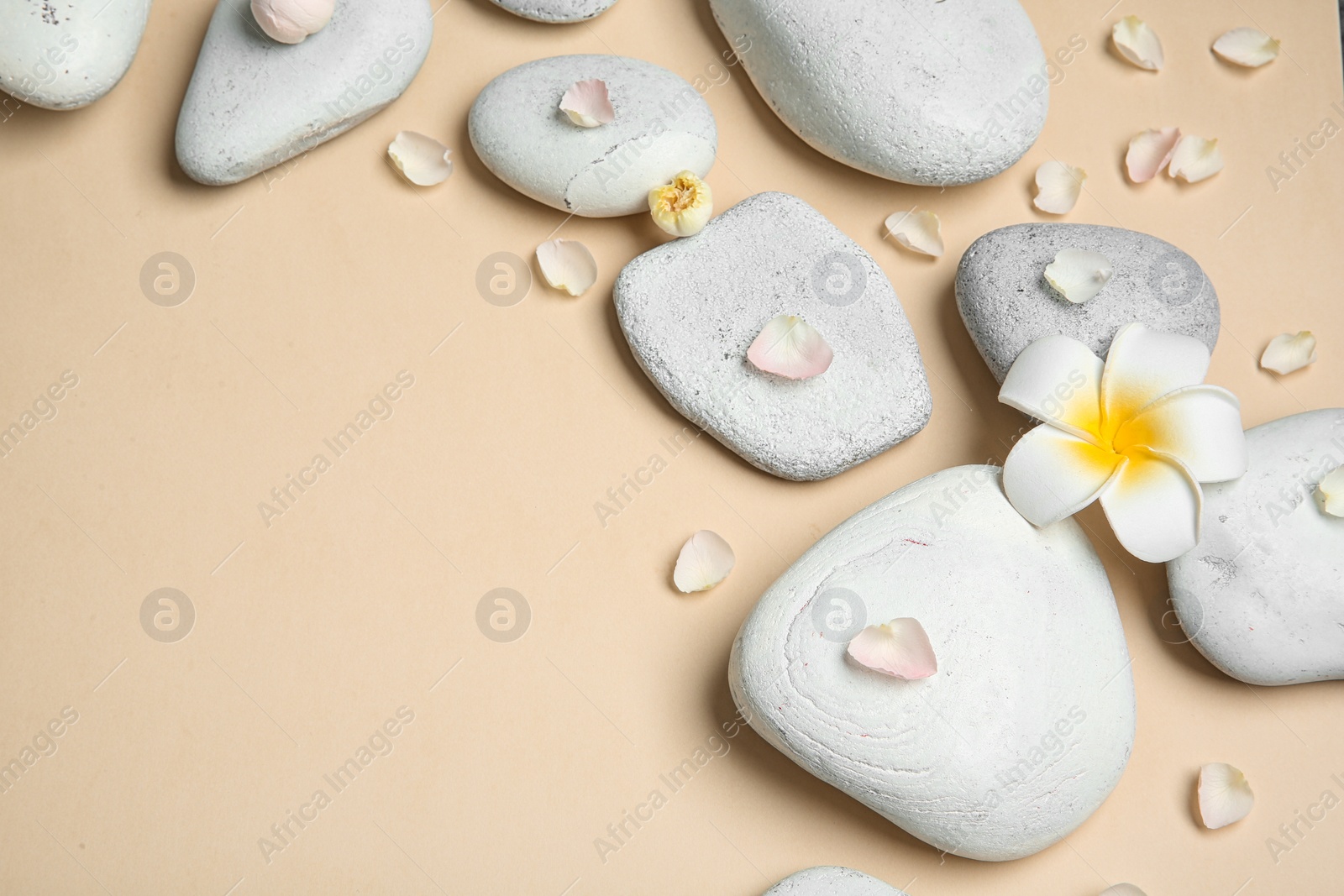 Photo of Flat lay composition with spa stones and space for text on color background