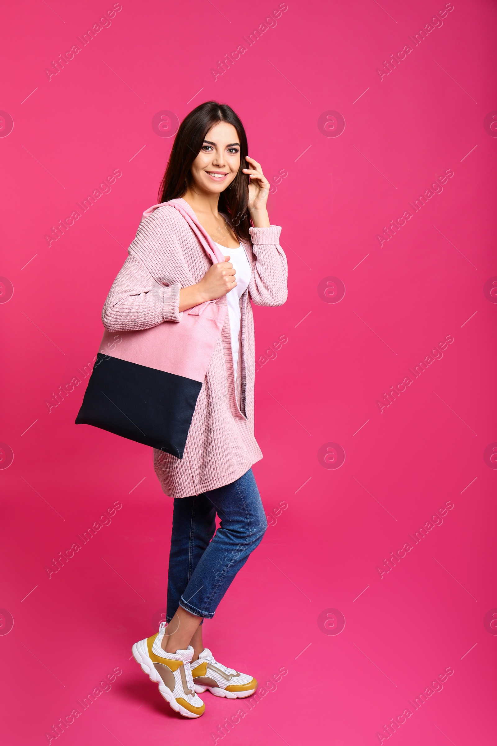 Photo of Full length portrait of young woman with textile bag on pink background