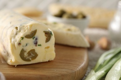 Photo of Tasty butter with olives and green onion on table, closeup. Space for text