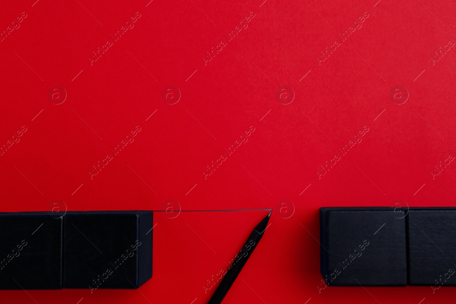 Photo of Pencil drawing bridge between blocks on red background, flat lay with space for text. Connection, relationships and deal concept