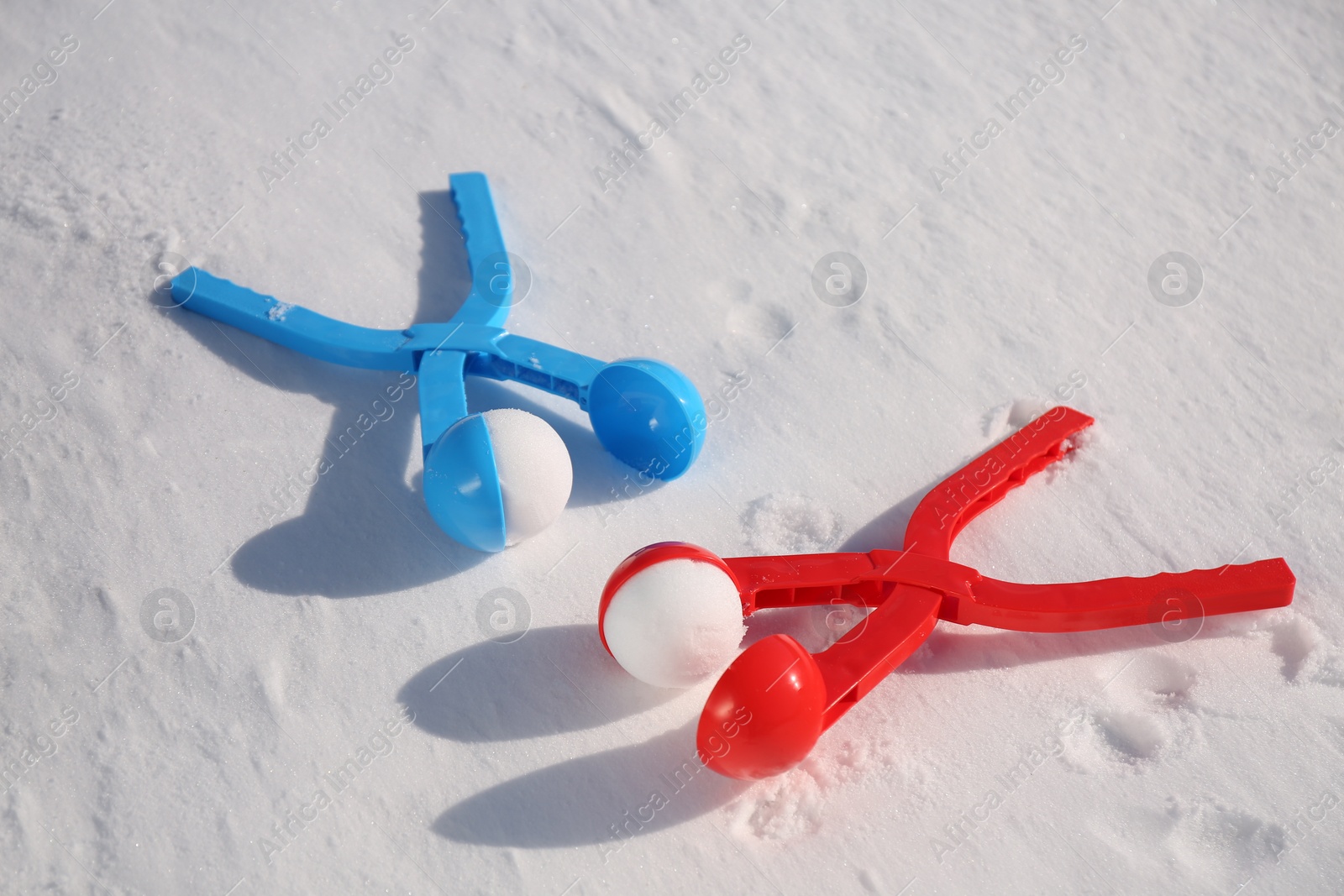 Photo of Snowballs and plastic tools outdoors on winter day