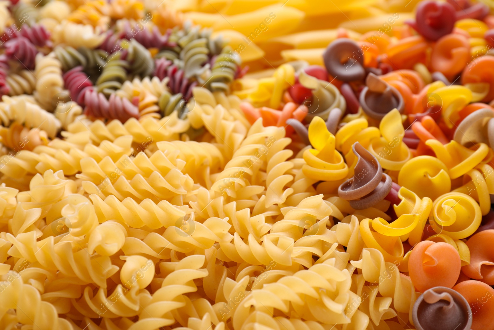 Photo of Different types of pasta as background, closeup