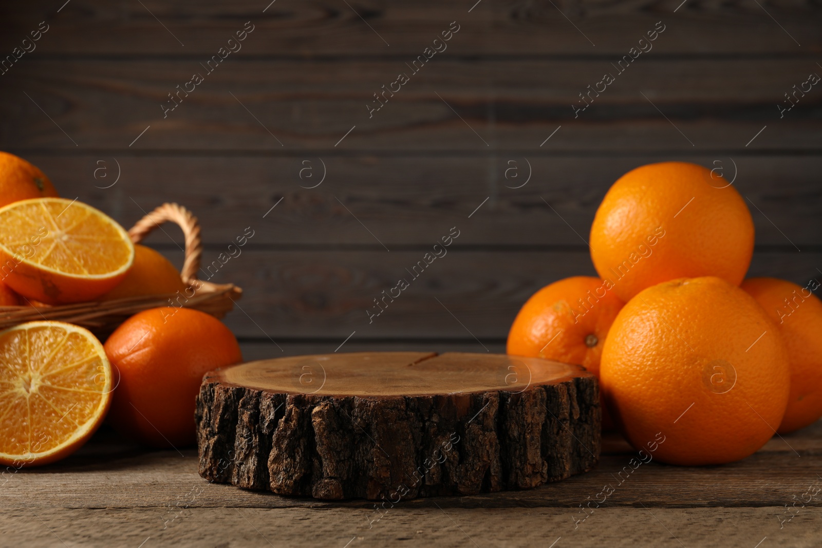 Photo of Fresh oranges on wooden table, space for text