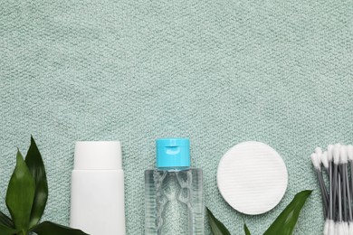 Photo of Flat lay composition with bottle of micellar cleansing water on turquoise towel, space for text