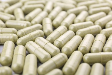 Many vitamin capsules as background, closeup view