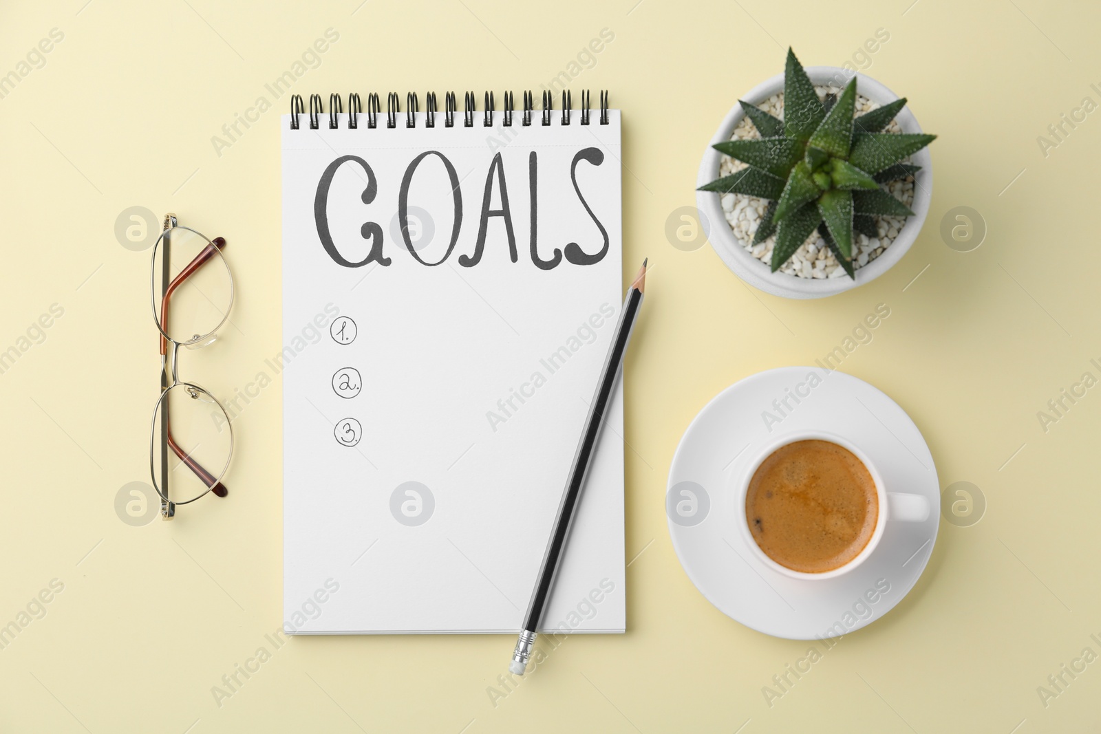 Photo of Planning concept. Empty list of goals in notebook and coffee on beige background, flat lay