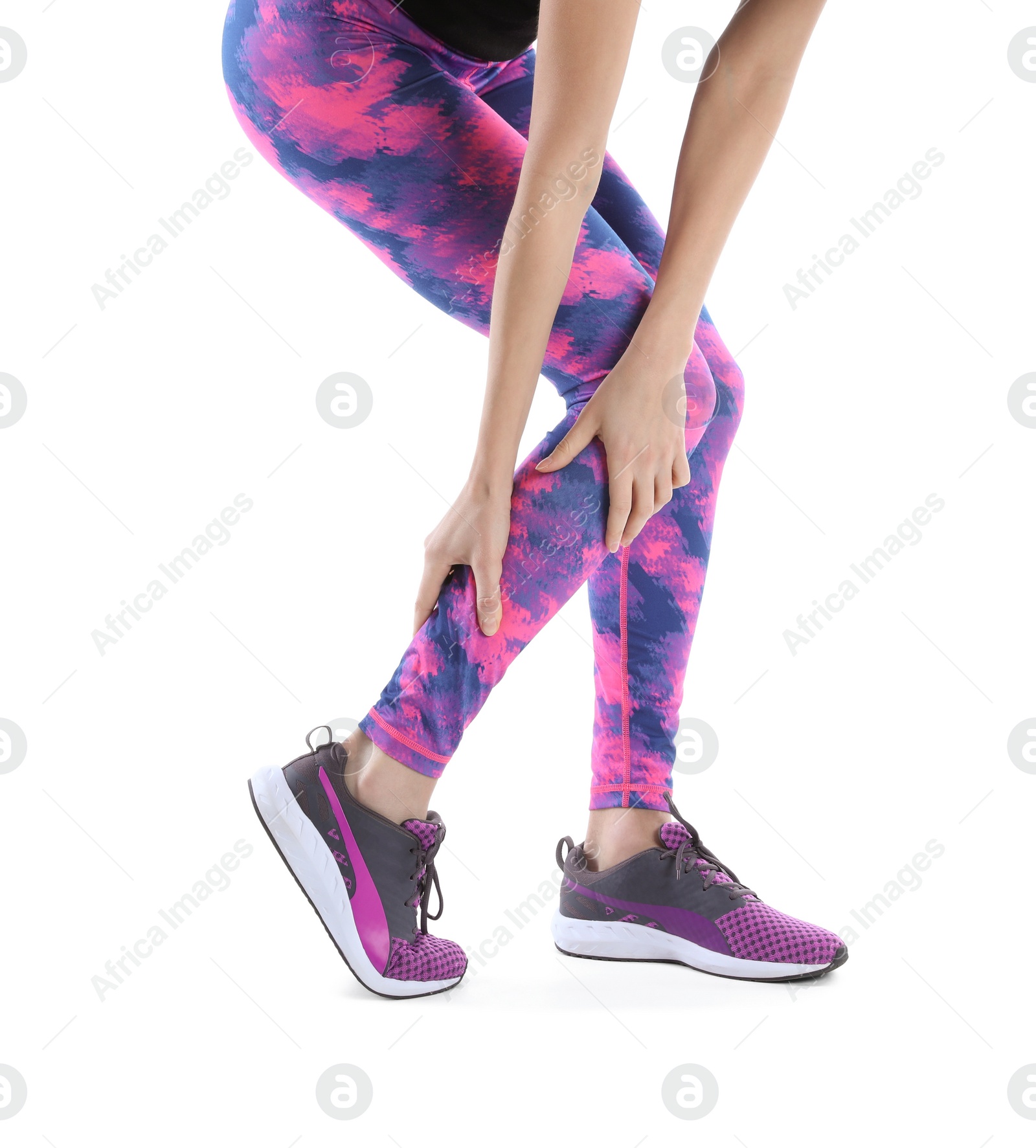 Photo of Young woman suffering from leg pain on white background, closeup