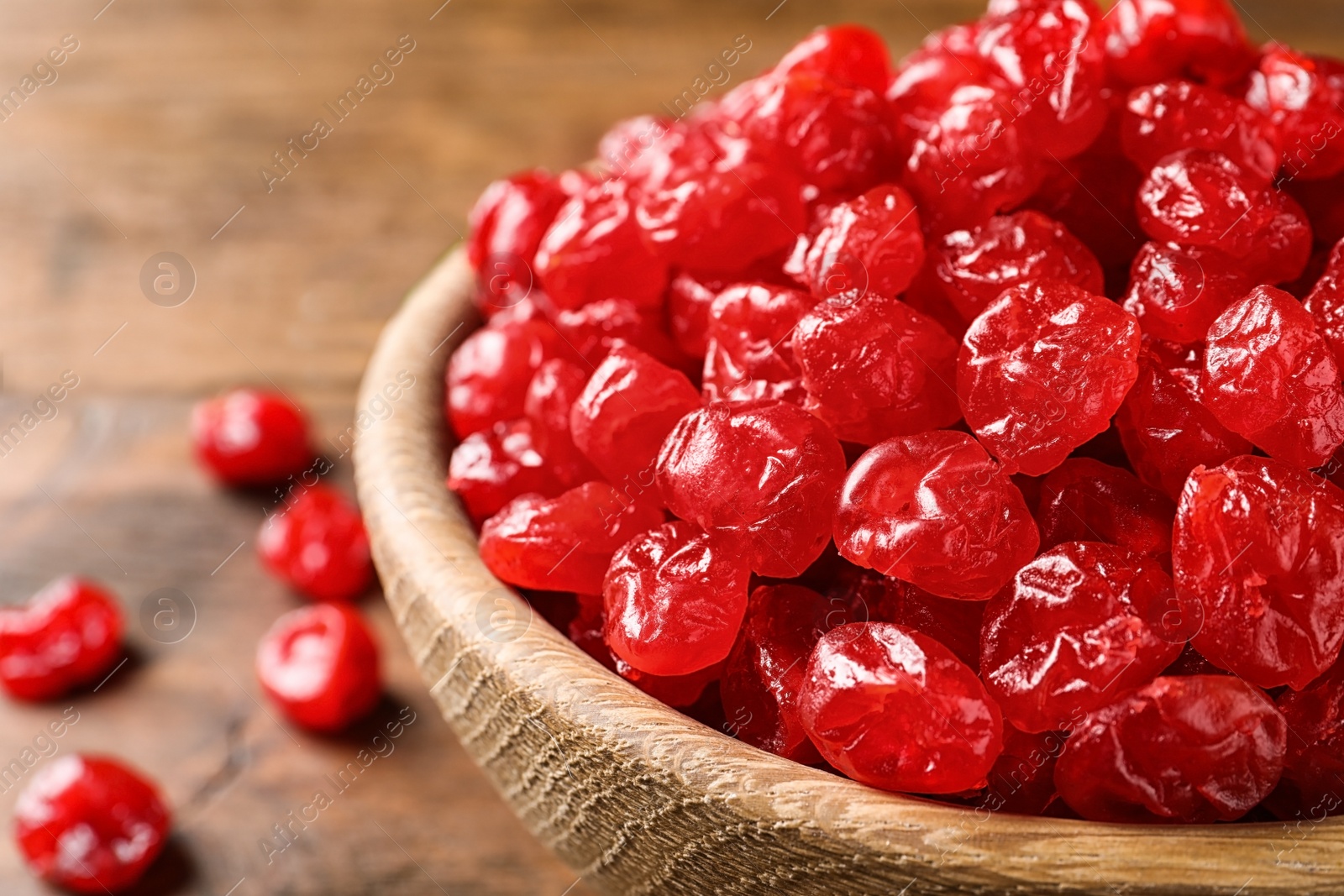 Photo of Bowl of tasty cherries on wooden background, closeup with space for text. Dried fruits as healthy food
