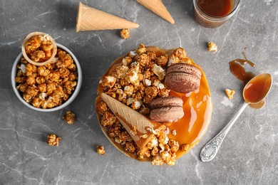 Photo of Delicious homemade cake with caramel sauce and popcorn on table, top view