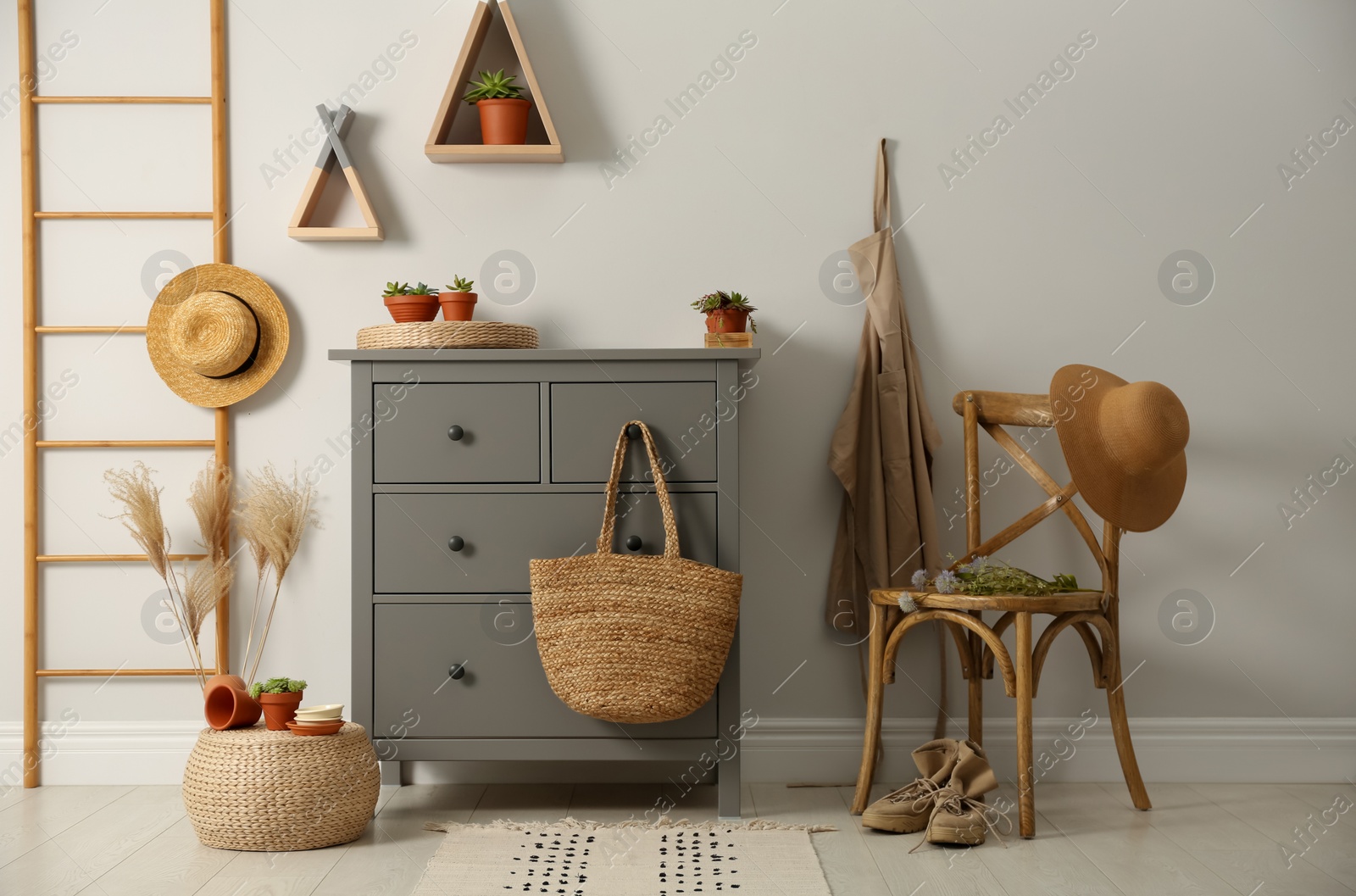 Photo of Grey chest of drawers in stylish room interior