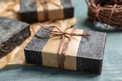 Natural tar soap on wooden table, closeup