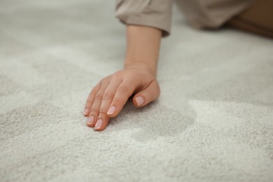 Photo of Woman touching soft white carpet, closeup view