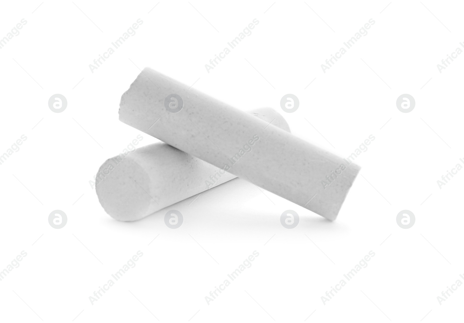 Photo of Small pieces of chalk on white background