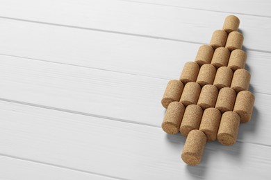 Photo of Christmas tree made of wine corks on white wooden table. Space for text