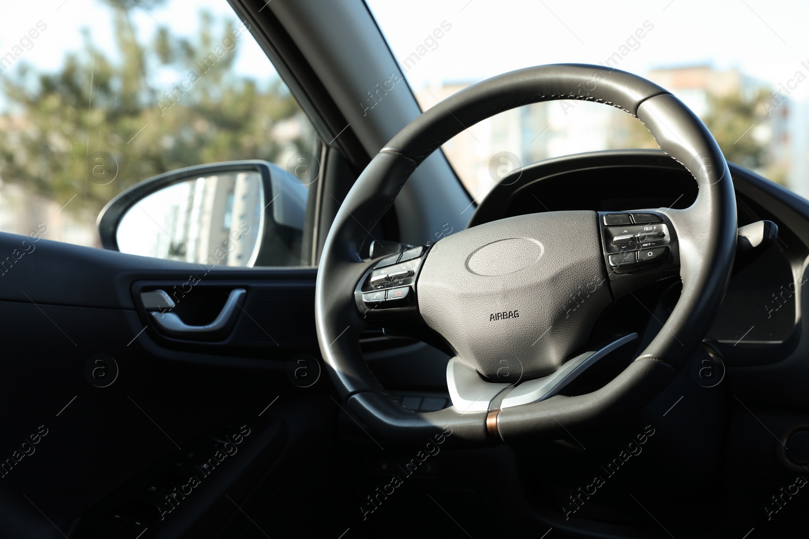 Photo of Black steering wheel inside of modern car