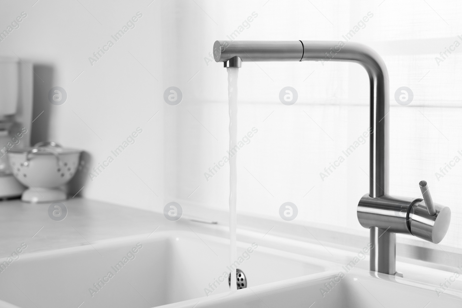 Photo of Stream of water flowing from tap in kitchen, space for text