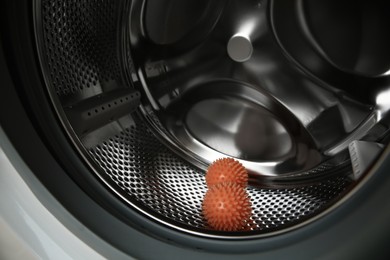 Dryer balls in washing machine drum, closeup