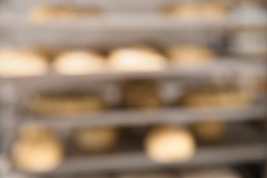 Photo of Blurred view of rack with pastries in workshop