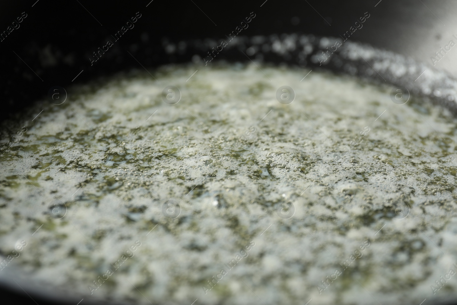 Photo of Melting butter in frying pan, closeup view