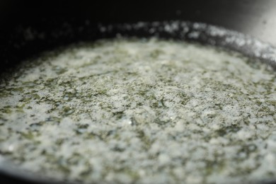 Photo of Melting butter in frying pan, closeup view