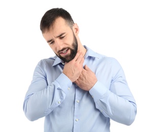 Photo of Young man suffering from sore throat on white background