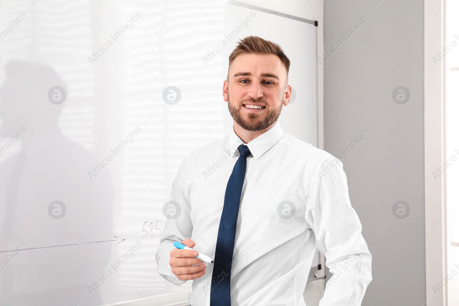 Photo of Professional business trainer near whiteboard in office