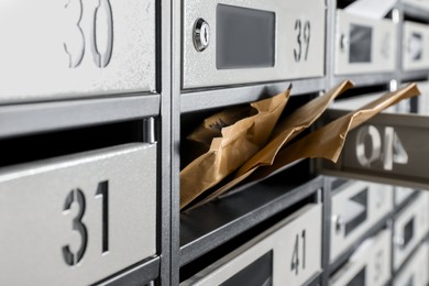 Photo of Open mailbox with keyhole, number and envelopes, closeup