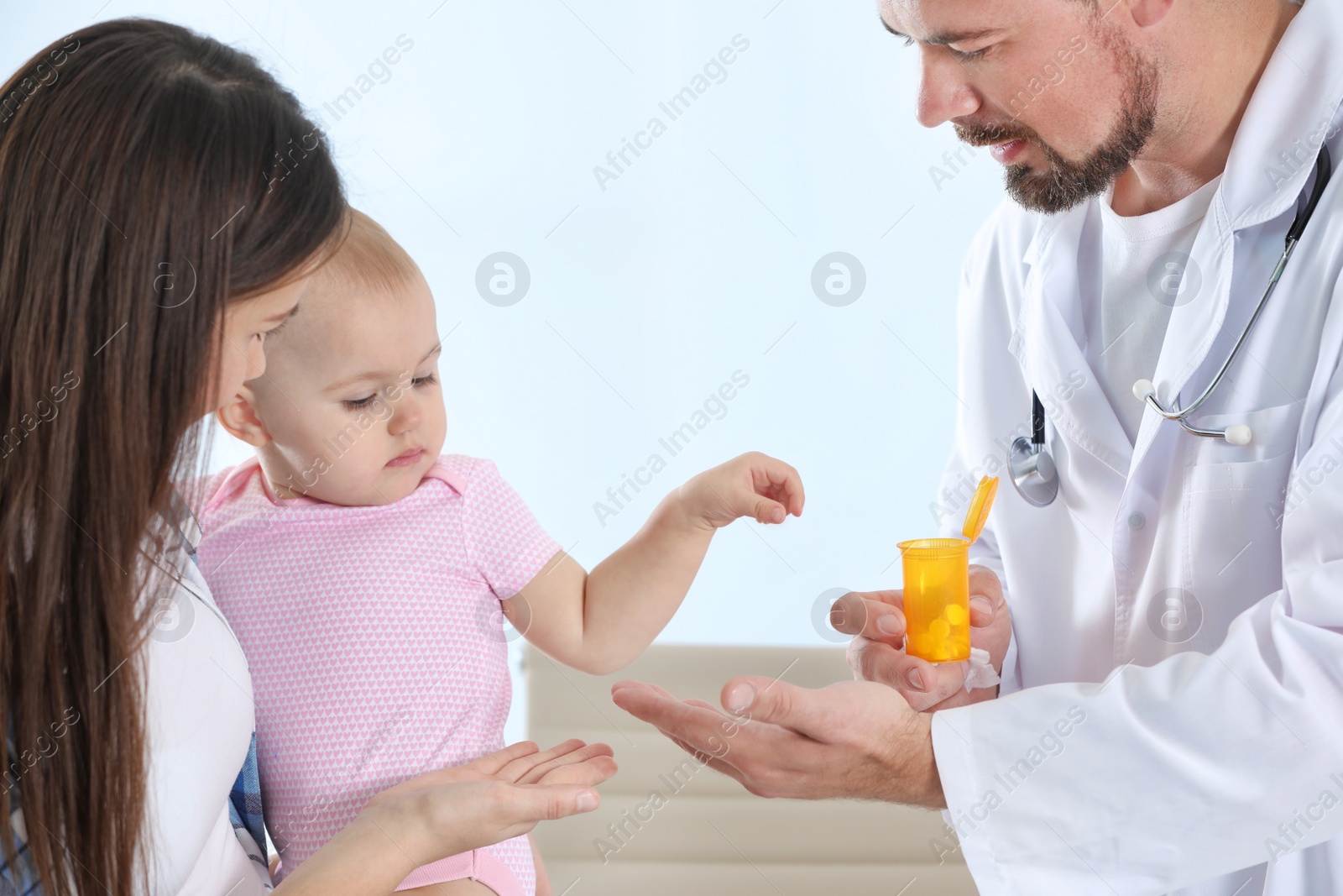 Photo of Woman with daughter visiting children's doctor in hospital