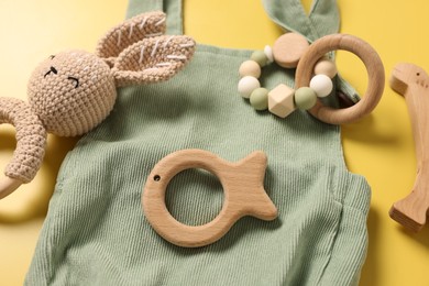 Photo of Different baby accessories on yellow background, closeup