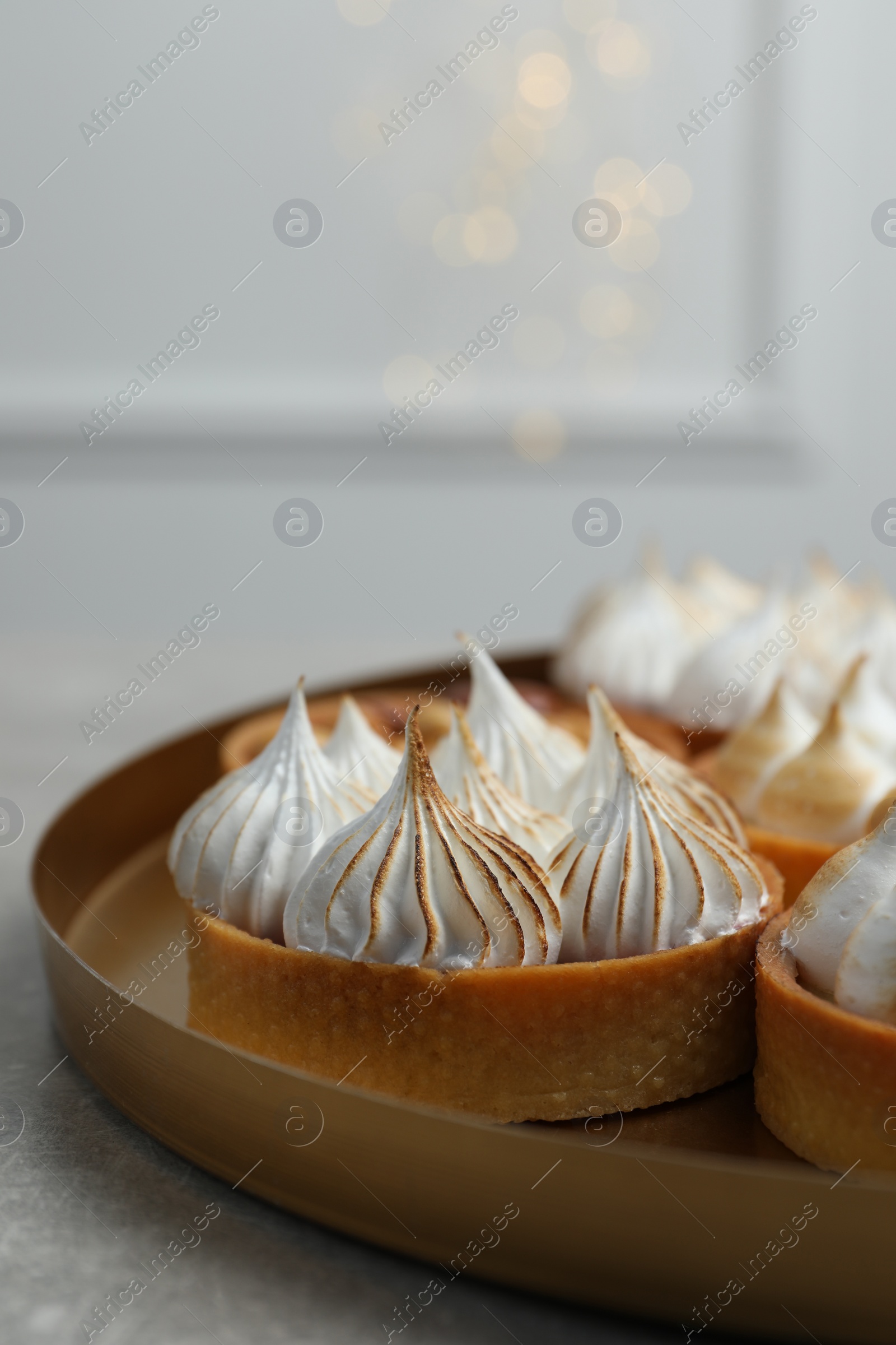 Photo of Many tartlets on grey table, space for text. Delicious dessert