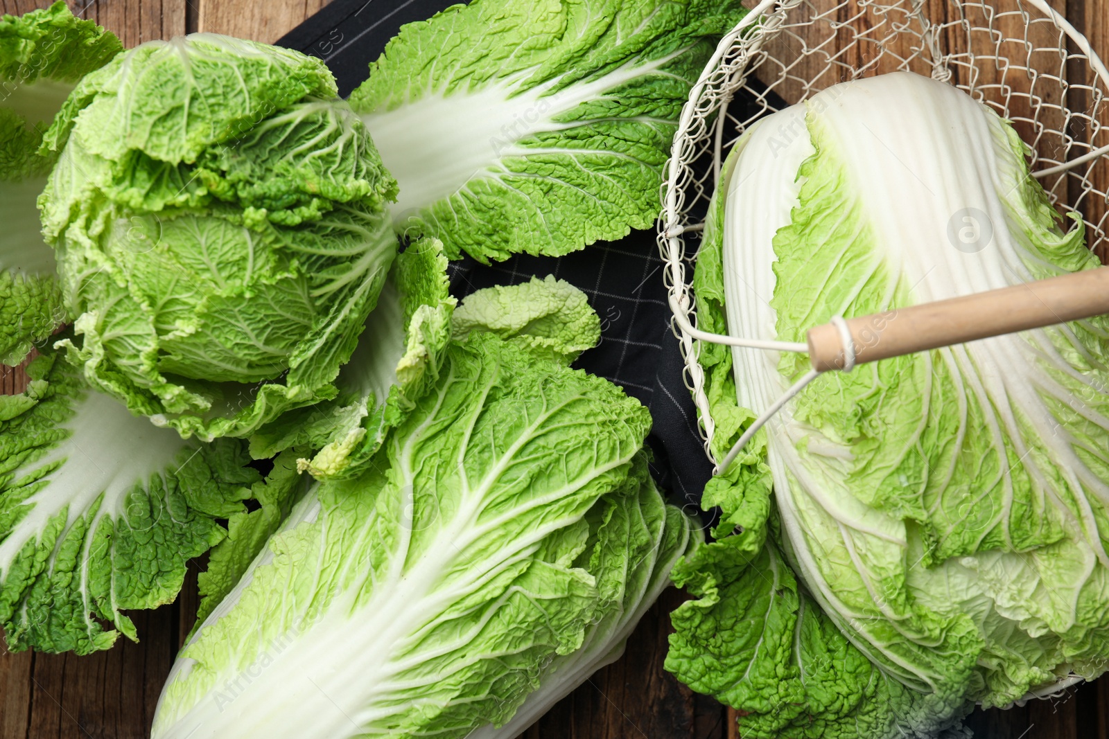 Photo of Raw Chinese cabbages on wooden table, flat lay