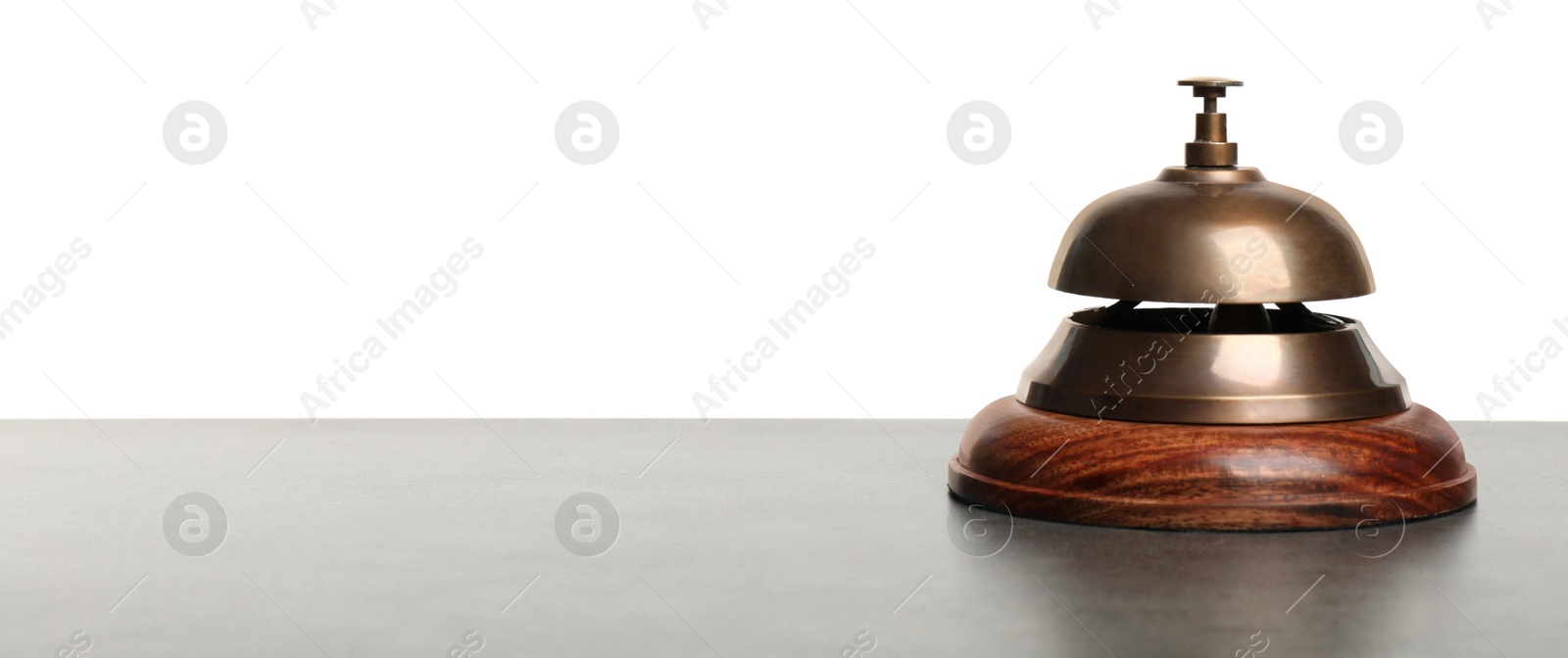 Photo of Hotel service bell on grey stone table against white background