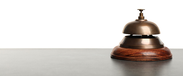 Hotel service bell on grey stone table against white background