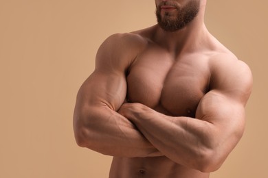 Photo of Muscular man on beige background, closeup. Sexy body