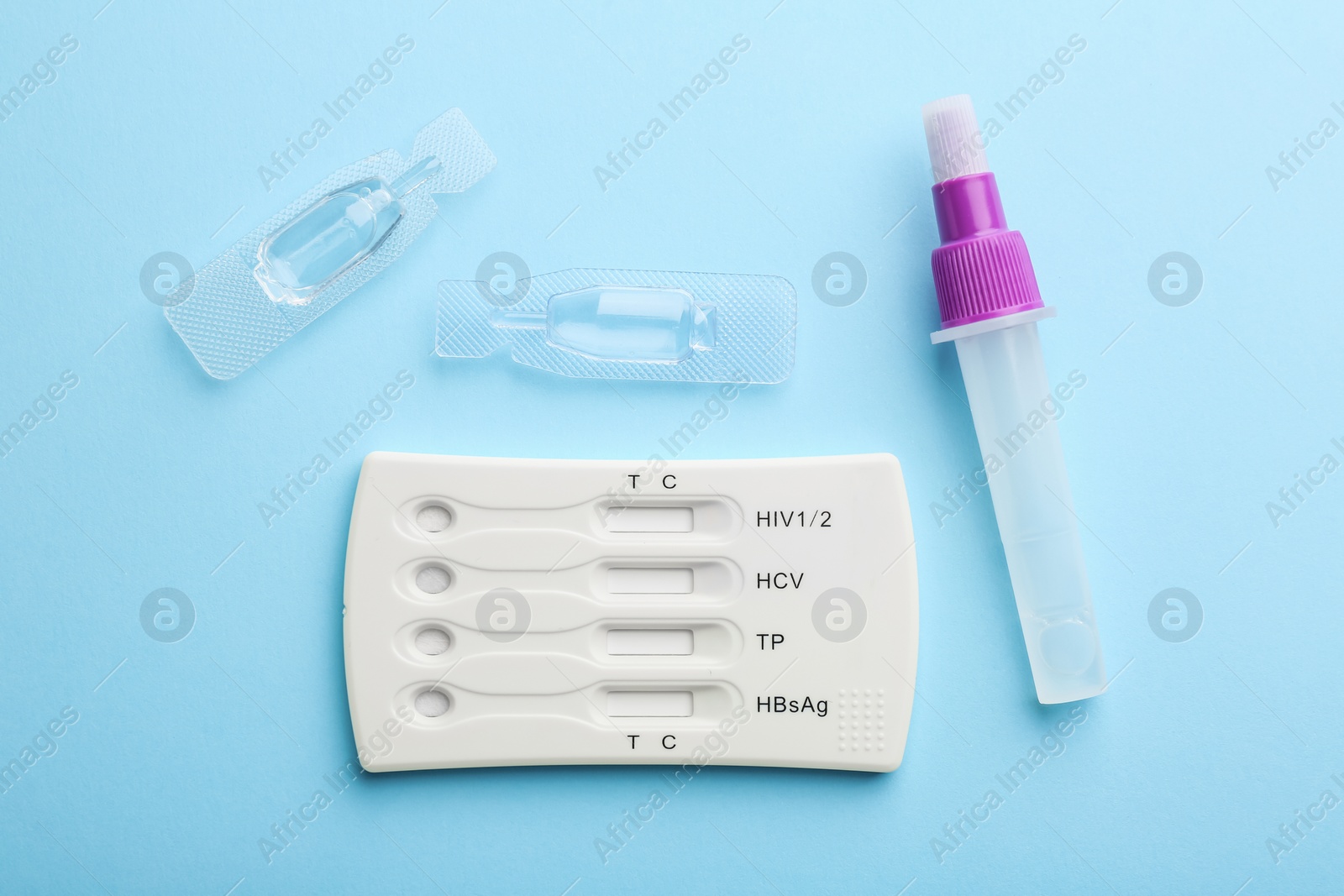 Photo of Disposable multi-infection express test kit on light blue background, flat lay