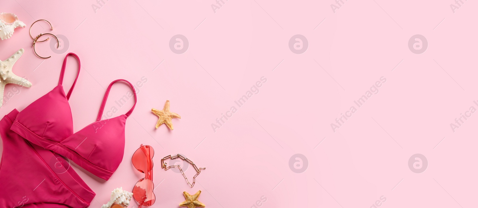 Photo of Beautiful bikini and beach accessories on pink background, flat lay. Space for text