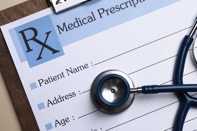 Photo of Clipboard with medical prescription form and stethoscope on beige background, top view