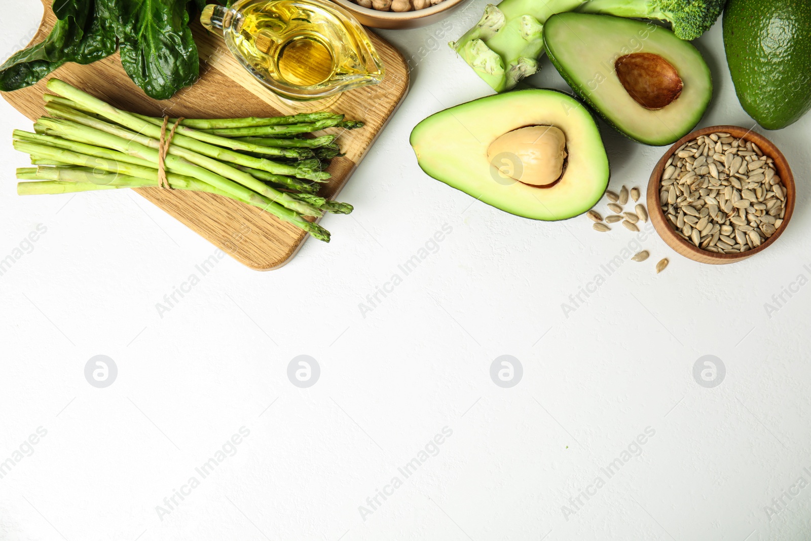 Photo of Different products rich in vitamin E on white background, flat lay