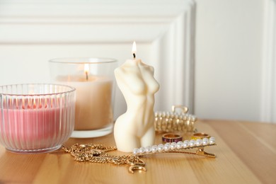Beautiful female body shape candle on wooden table. Stylish decor