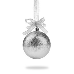 Image of Beautiful silver Christmas ball with bow hanging on white background