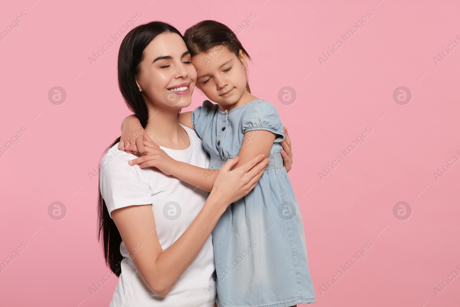 Photo of Happy woman with her cute daughter on pink background, space for text. Mother's day celebration