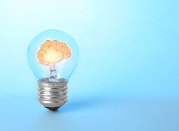 Image of Lamp bulb with human brain inside on blue background, space for text. Idea generation