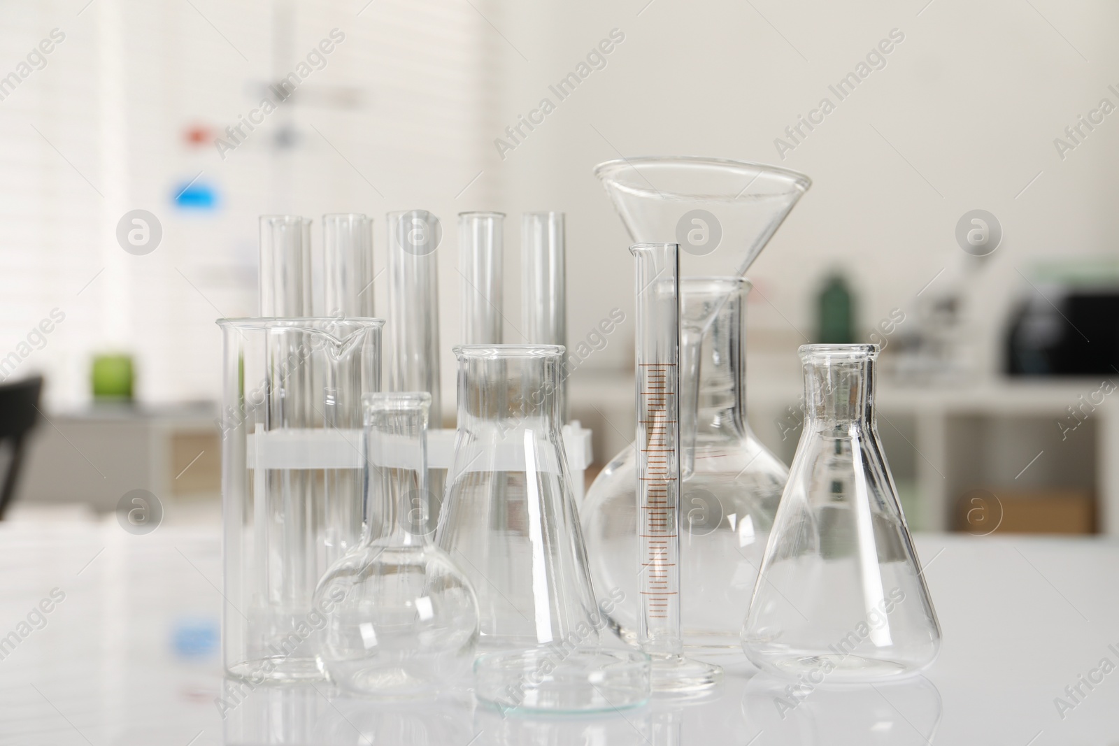 Photo of Laboratory analysis. Different glassware on white table indoors